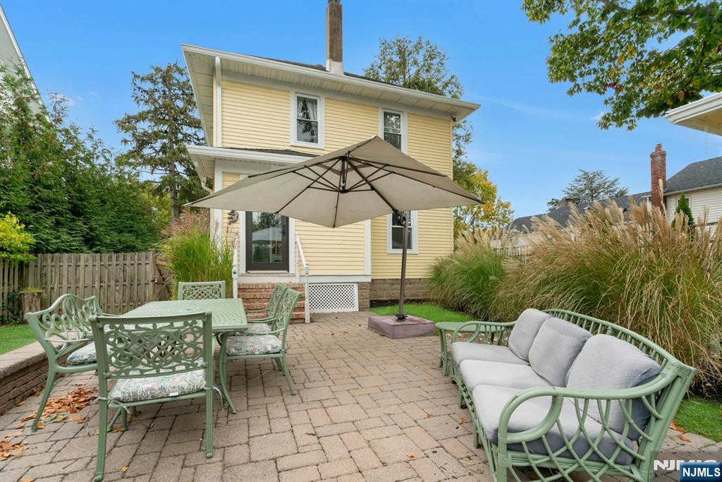 409 Warren Avenue Ho-Ho-Kus, NJ 07423 - Photo 20 of 23 a backyard of a house with table and chairs