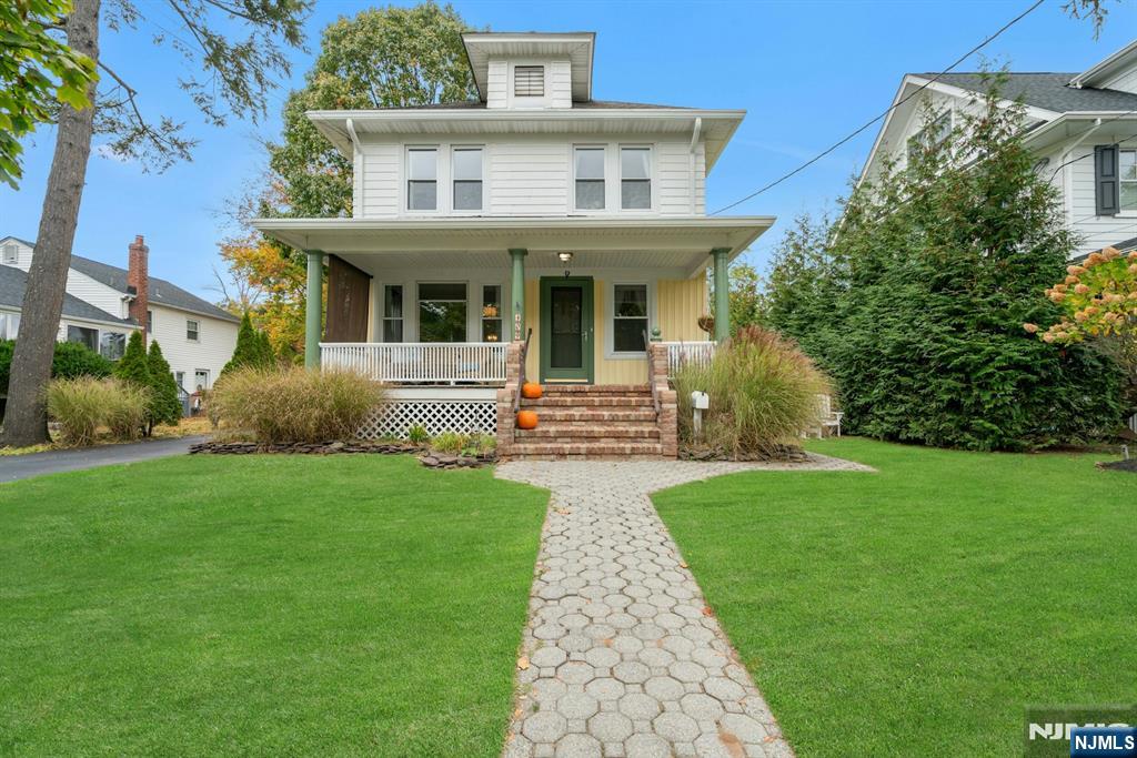 409 Warren Avenue Ho-Ho-Kus, NJ 07423 - Photo 2 of 23 a front view of a house with garden