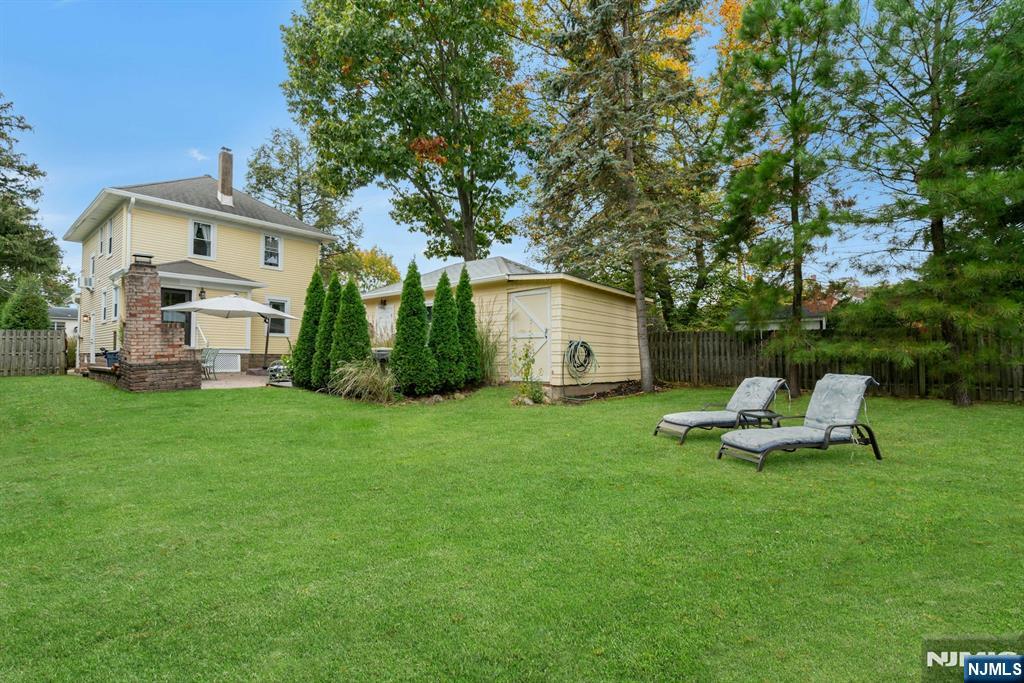 409 Warren Avenue Ho-Ho-Kus, NJ 07423 - Photo 22 of 23 a view of a house with backyard sitting area and garden