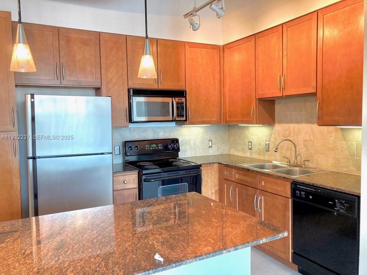 2001 Biscayne Boulevard, Unit 2608 Miami, FL 33137 - Photo 2 of 10 a kitchen with a sink a microwave a stove and refrigerator