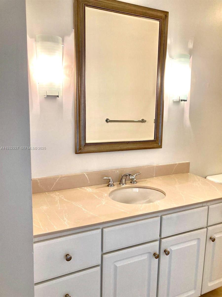 2001 Biscayne Boulevard, Unit 2608 Miami, FL 33137 - Photo 5 of 10 a bathroom with a sink and a mirror