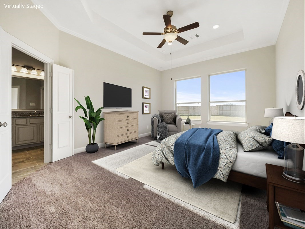 3308 Bentwood Ranch Drive Conroe, TX 77385 - Photo 6 of 24 a spacious bedroom with a bed a couch and a flat screen tv