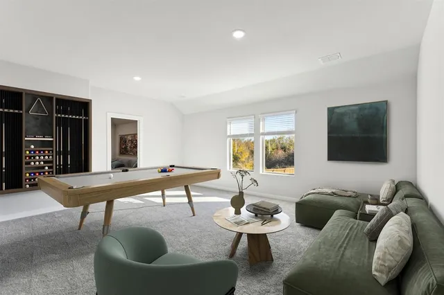 a living room with furniture potted plant and a window