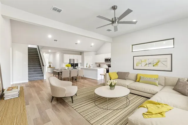 a living room with furniture and a wooden floor