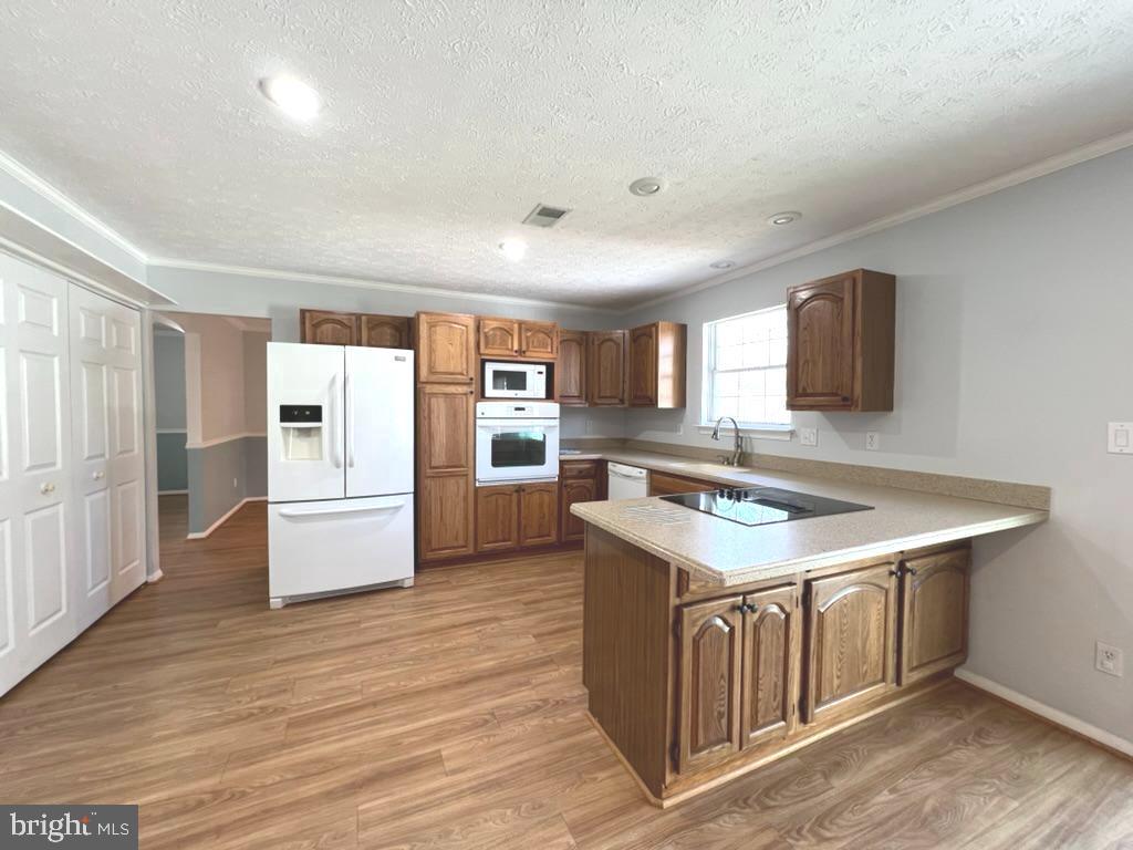 8220 Grainfield Road Severn, MD 21144 - Photo 6 of 23 a kitchen with a stove a refrigerator and a sink