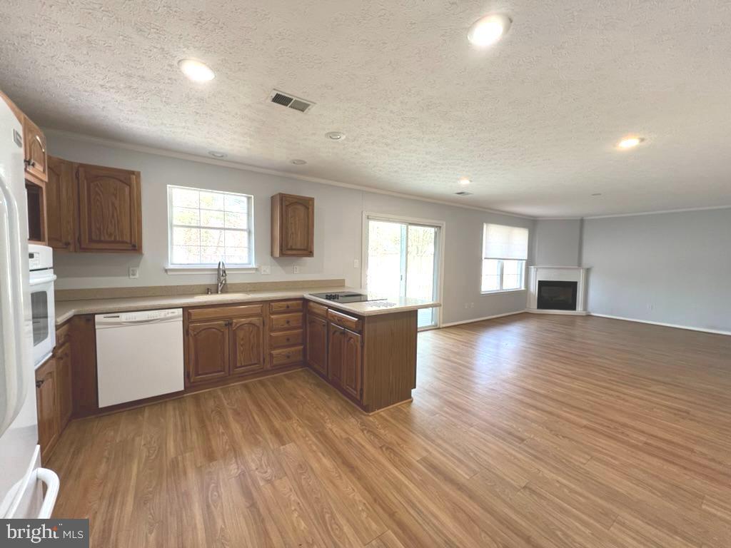 8220 Grainfield Road Severn, MD 21144 - Photo 7 of 23 a large kitchen with a lot of counter space and wooden floor