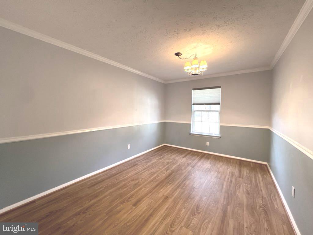 8220 Grainfield Road Severn, MD 21144 - Photo 9 of 23 wooden floor in an empty room with a window