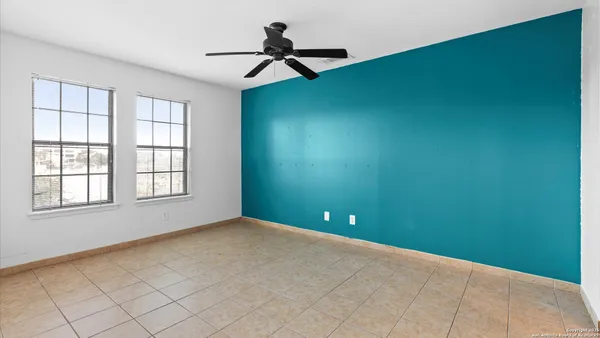 a view of a livingroom with a ceiling fan and window