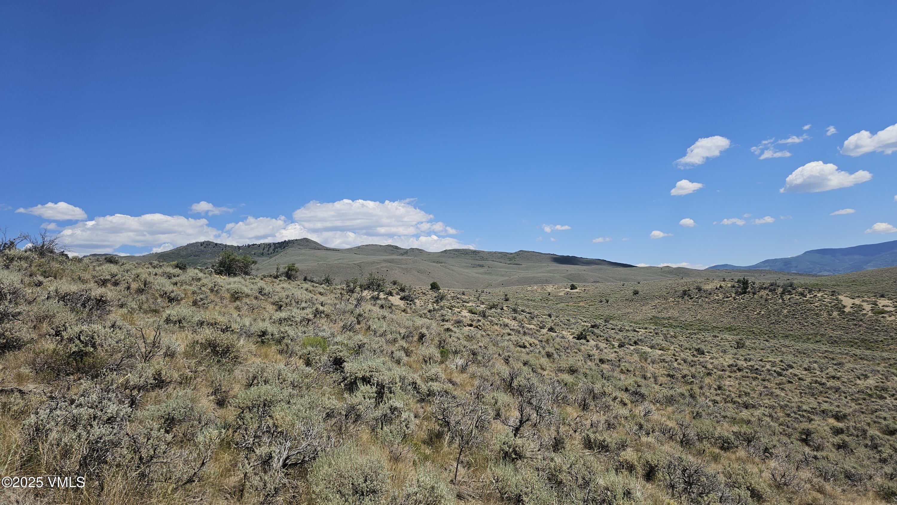 1 Horse Mountain Ranch Road Wolcott, CO 81655 - Photo 19 of 49 a view of a dry yard with mountains in the background