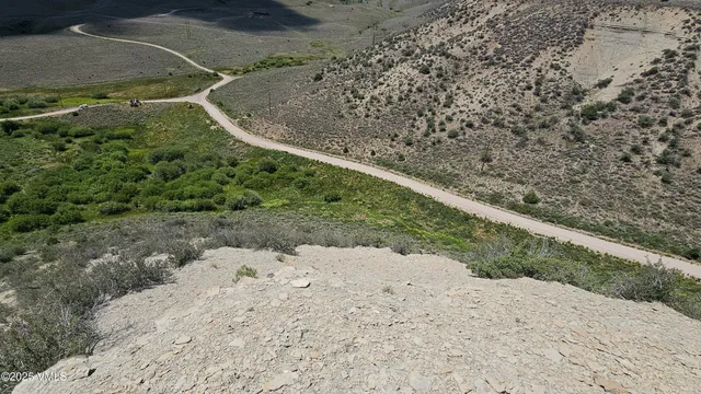 a view of a dry yard with wooden fence