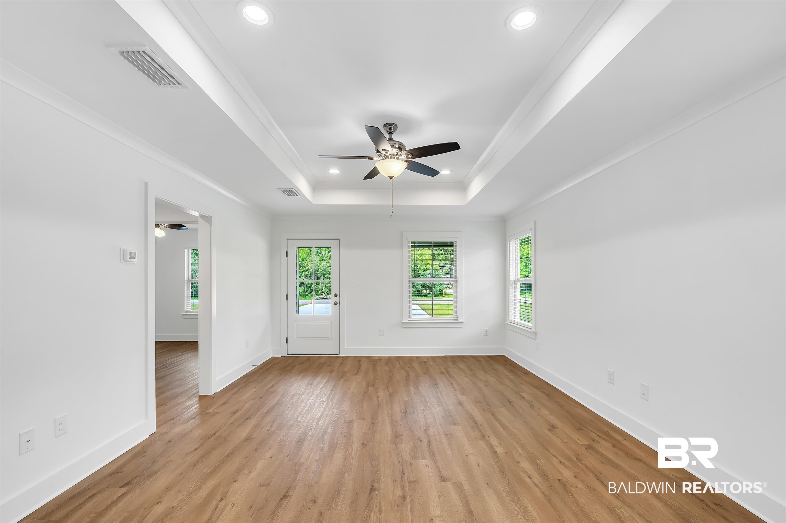 22045 8th Street Silverhill, AL 36576 - Photo 6 of 39 Living Room with ceiling fan, recessed lighting, a raised ceiling, light wood finished floors, and baseboards