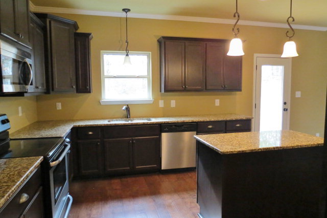 356 Walnut Grove Road Gray, GA 31032 - Photo 13 of 27 a kitchen with granite countertop a sink and a stove