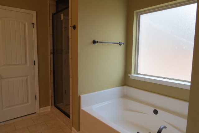 356 Walnut Grove Road Gray, GA 31032 - Photo 19 of 27 a bathroom with a tub and shower
