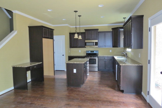 356 Walnut Grove Road Gray, GA 31032 - Photo 3 of 27 a kitchen with stainless steel appliances kitchen island granite countertop a refrigerator a sink a stove and a cabinets