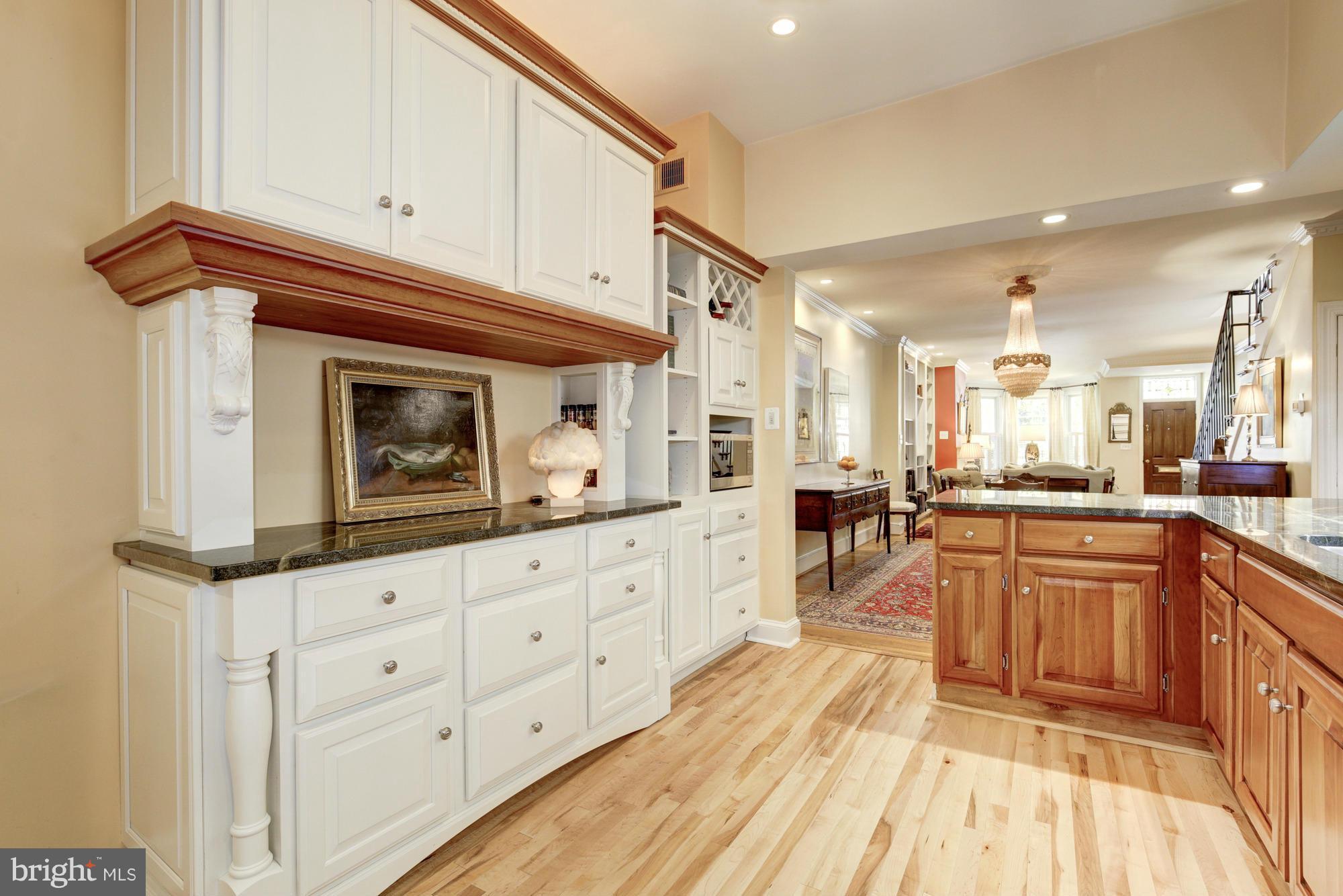 137 D Street Southeast Washington, DC 20003 - Photo 11 of 27 a kitchen with granite countertop white cabinets and white appliances