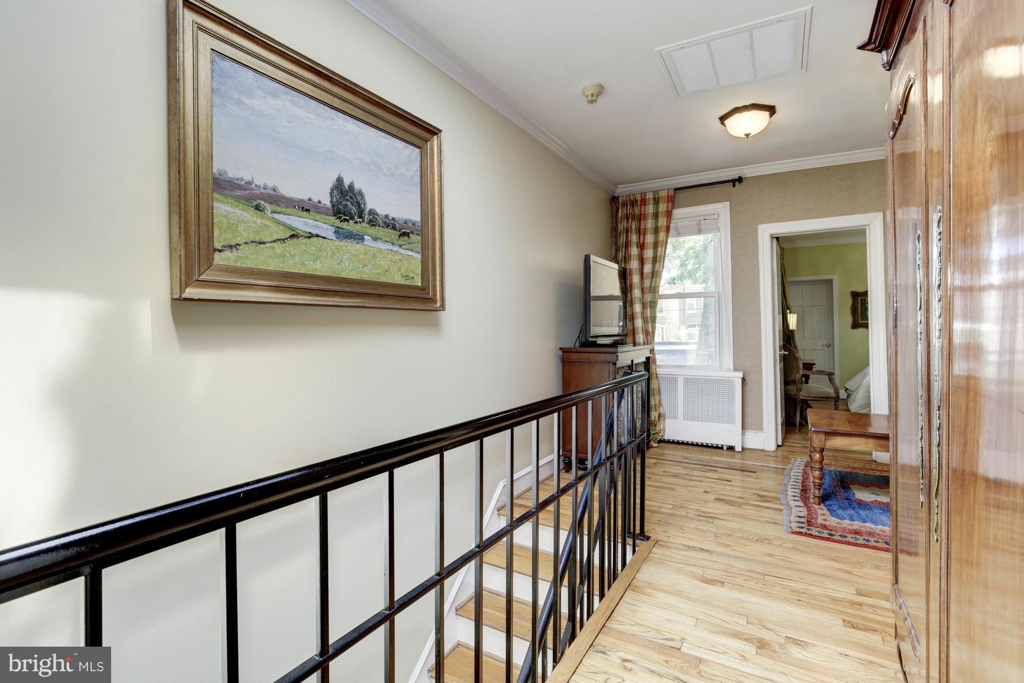 137 D Street Southeast Washington, DC 20003 - Photo 15 of 27 a view of a hallway with wooden floor and a bathroom
