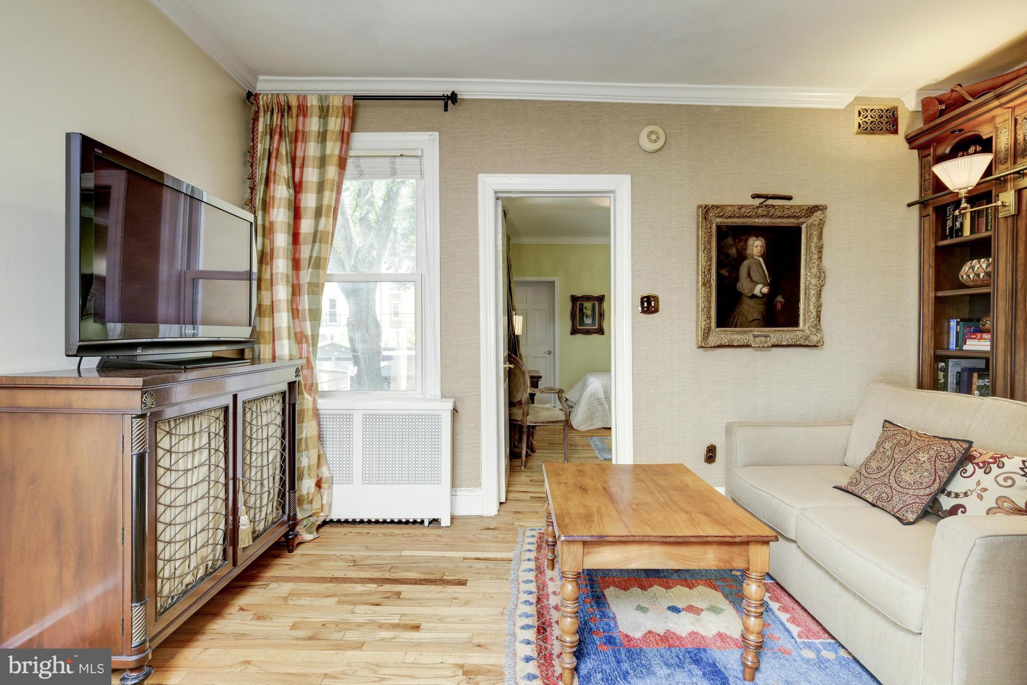 137 D Street Southeast Washington, DC 20003 - Photo 16 of 27 a living room with furniture a flat screen tv and a table