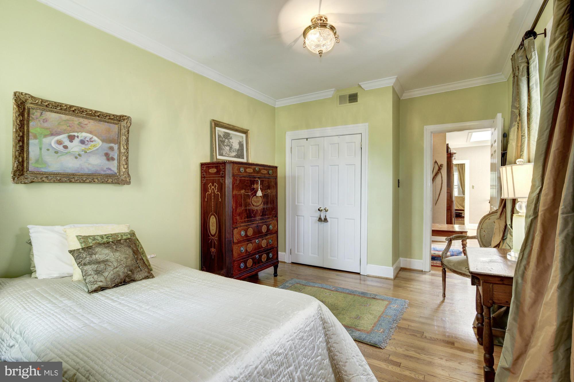 137 D Street Southeast Washington, DC 20003 - Photo 22 of 27 a bedroom with a bed and a chandelier