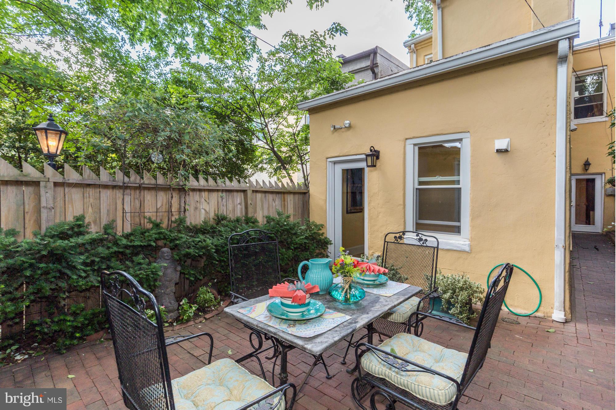 137 D Street Southeast Washington, DC 20003 - Photo 24 of 27 a backyard of a house with table and chairs