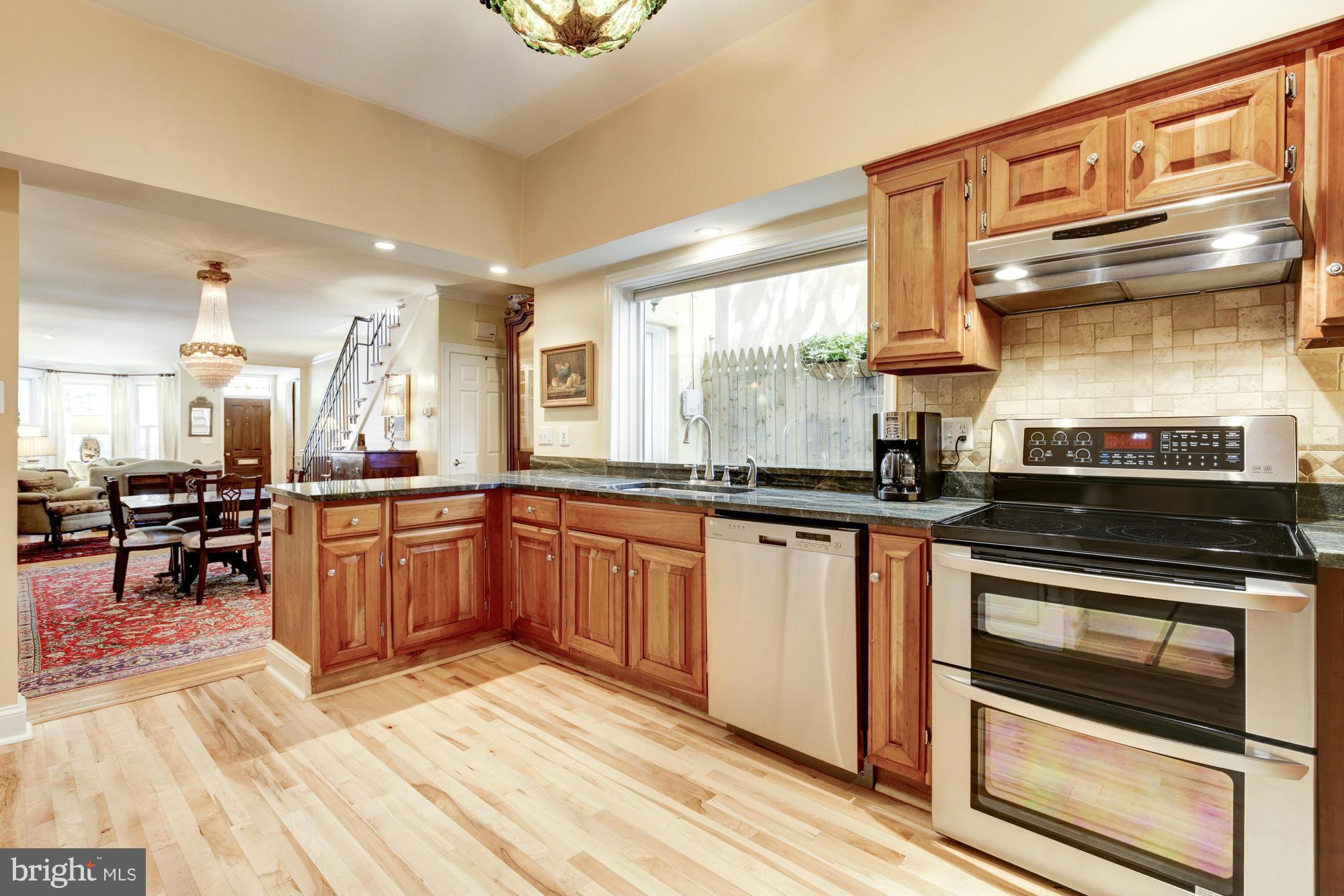 137 D Street Southeast Washington, DC 20003 - Photo 10 of 27 a kitchen with stainless steel appliances granite countertop a stove and a sink