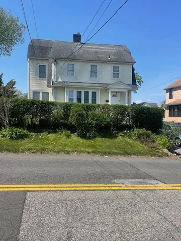 a front view of a house with a yard and a garage