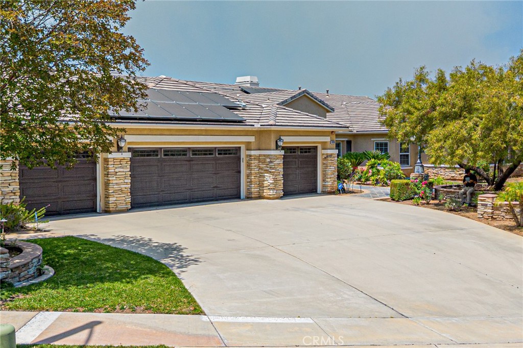 4088 Shady Ridge Circle Corona, CA 92881 - Photo 8 of 47 a front view of a house with a yard and garage