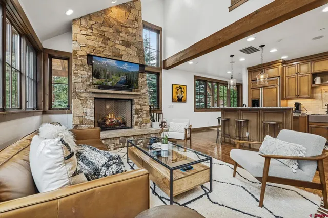 a living room with furniture a flat screen tv and a fireplace