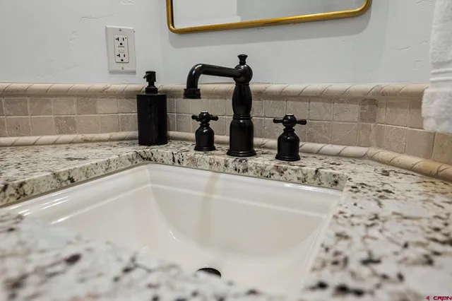 a spacious bedroom with a bed and a desk