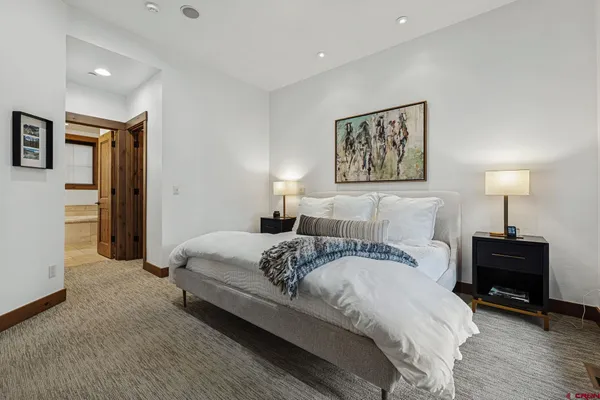 a bedroom with a large bed and a large window