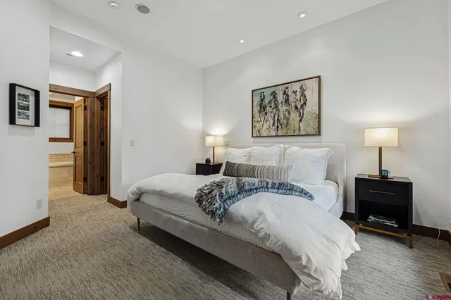 a bedroom with a large bed and a large window