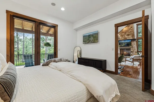 a bedroom with a bed painting and wooden floor