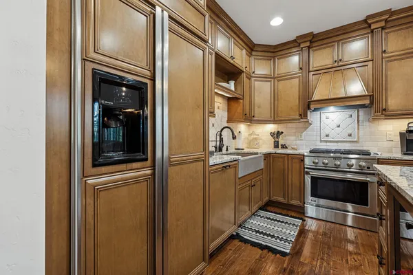 a kitchen with stainless steel appliances granite countertop a refrigerator and a sink
