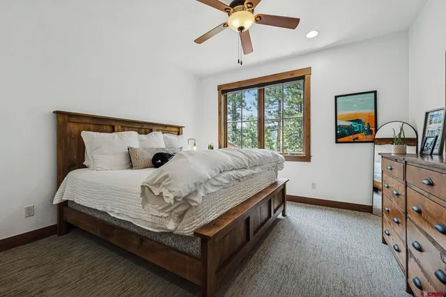 a bedroom with a large bed and a large window