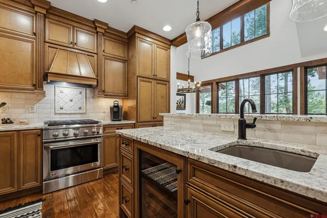 a kitchen with stainless steel appliances granite countertop a sink and a stove