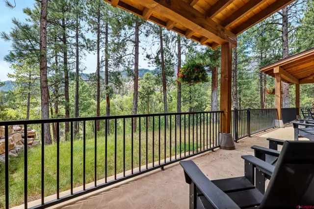 a view of a lush green hillside and a houses
