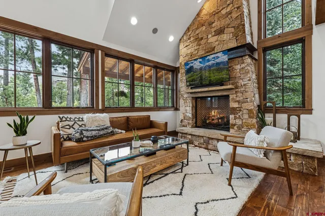 a living room with furniture and a floor to ceiling window