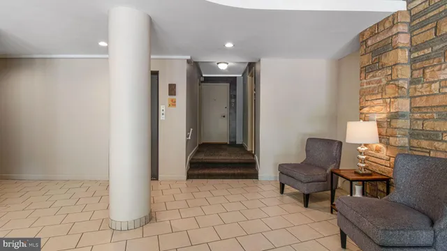 a bathroom with a toilet and a glass door shower