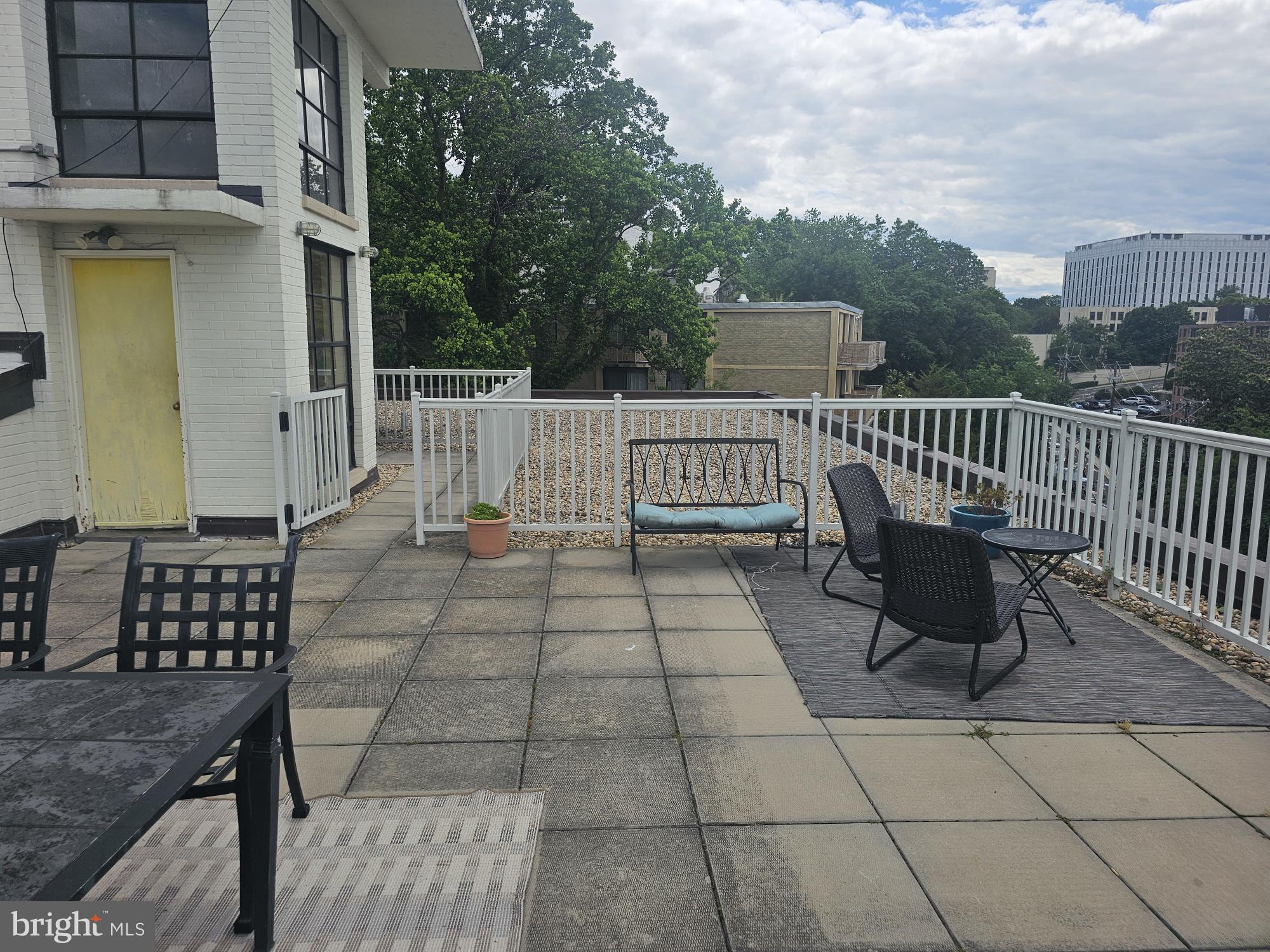 3901 Tunlaw Road Northwest, Unit 701 Washington, DC 20007 - Photo 15 of 17 a view of a chairs and table on the terrace
