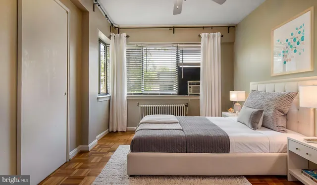 a bedroom with a large bed and a window