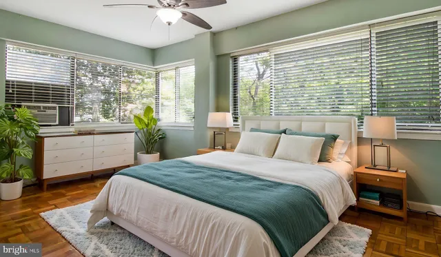 a bedroom with a large bed and a large window