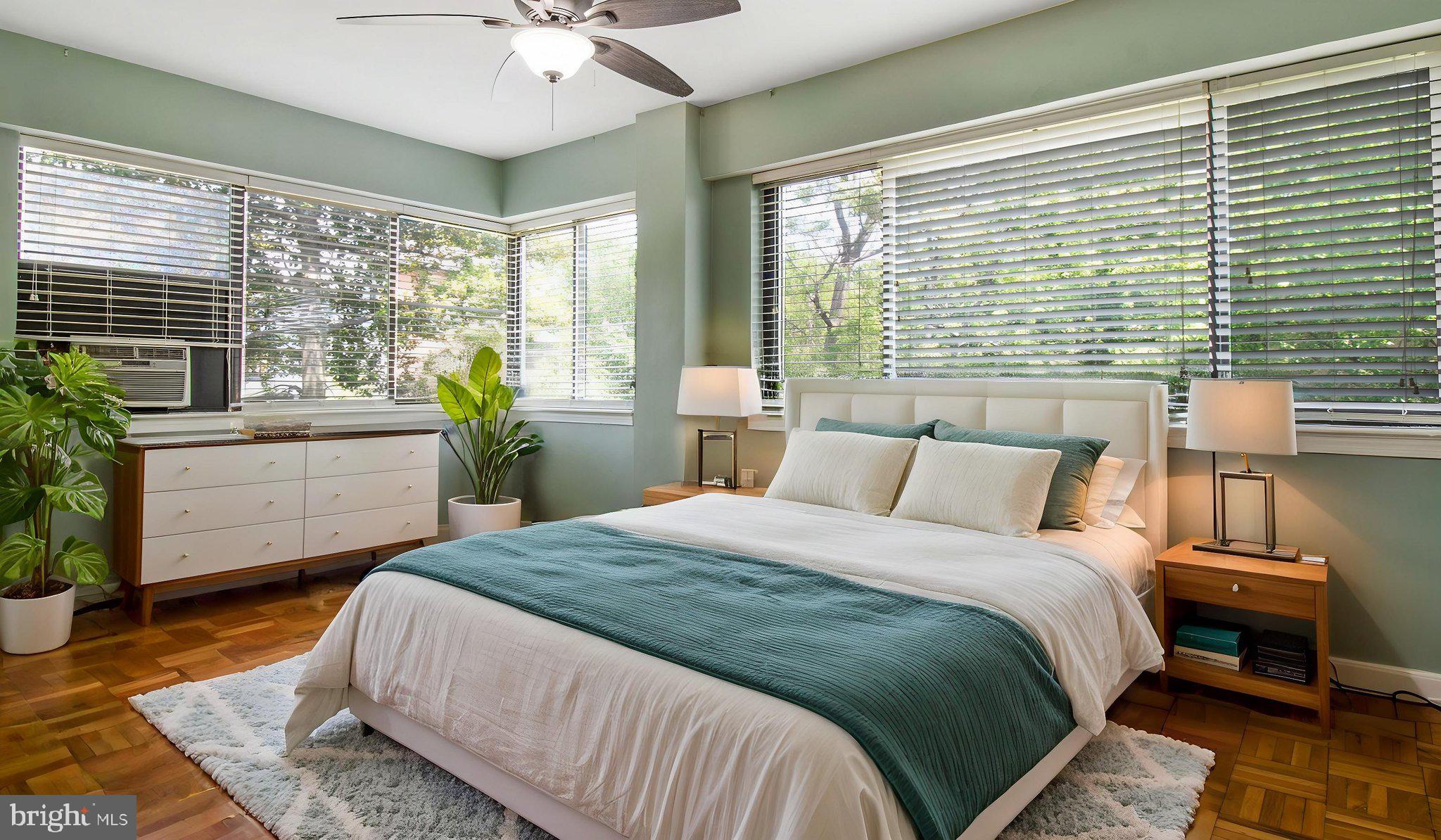 3901 Tunlaw Road Northwest, Unit 701 Washington, DC 20007 - Photo 8 of 17 a bedroom with a large bed and a large window
