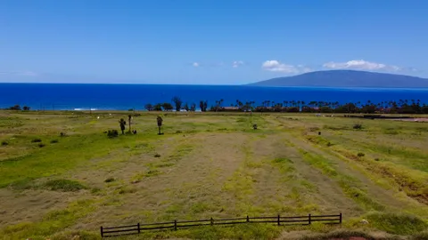 a view of an ocean beach and a mountain