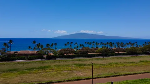 a view of an ocean with mountains in the background