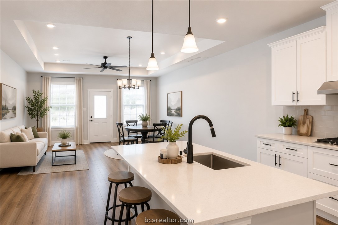 2012 Reagan Court Bryan, TX 77802 - Photo 4 of 19 a kitchen with a dining table chairs refrigerator and cabinets