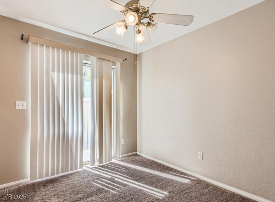 3950 South Sandhill Road, Unit 121 Las Vegas, NV 89121 - Photo 9 of 11 Empty room featuring carpet floors and ceiling fan