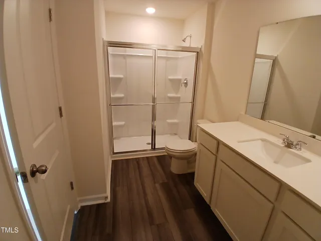 a bathroom with a sink a toilet and a shower