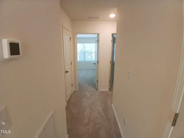 a view of a bathroom from a hallway