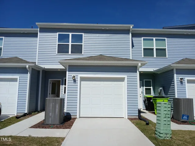 a front view of a house with garage
