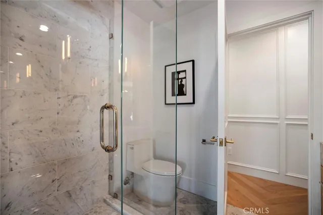 a bathroom with a granite countertop toilet sink and mirror