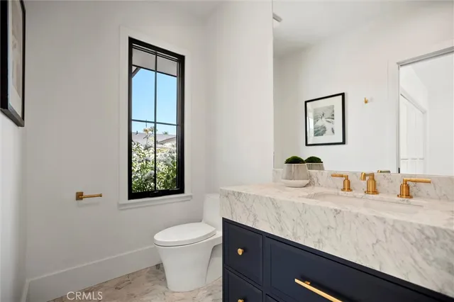 a spacious bedroom with a bed a couch and a window